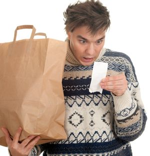 In this file photo, a male model wearing an annoying sweater feigns alarm at a receipt while you fantasize about punching him the face.